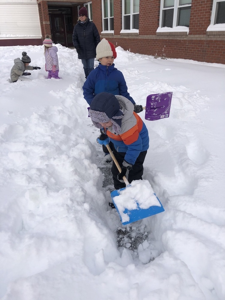Children shoveling snow